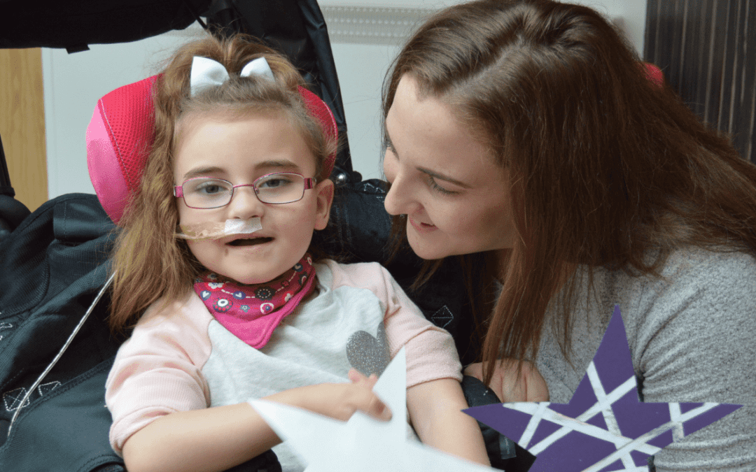 Little girl smiling with her mum at the hospice