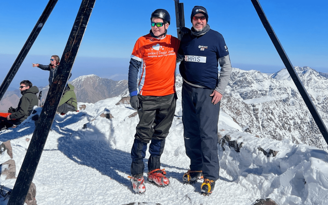 Phil and Chris standing on top of a snowy mountain
