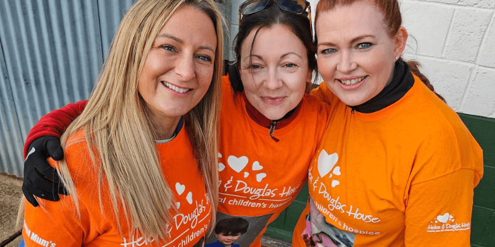 Nicky, Rachel and Mary 'Angel Mums' posing together in orange tshirts